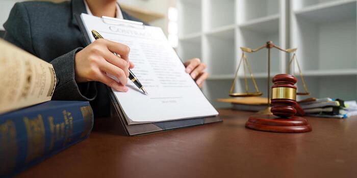 https://tharaniassociates.in/wp-content/uploads/2026/07/lawyer-signing-important-legal-agreement-in-office-photo.jpg